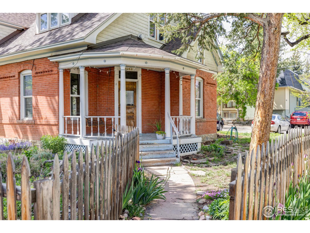 1843 Grove Street Boulder, CO 80302 - Photo 2 of 16 a view of a house with a small yard and wooden fence