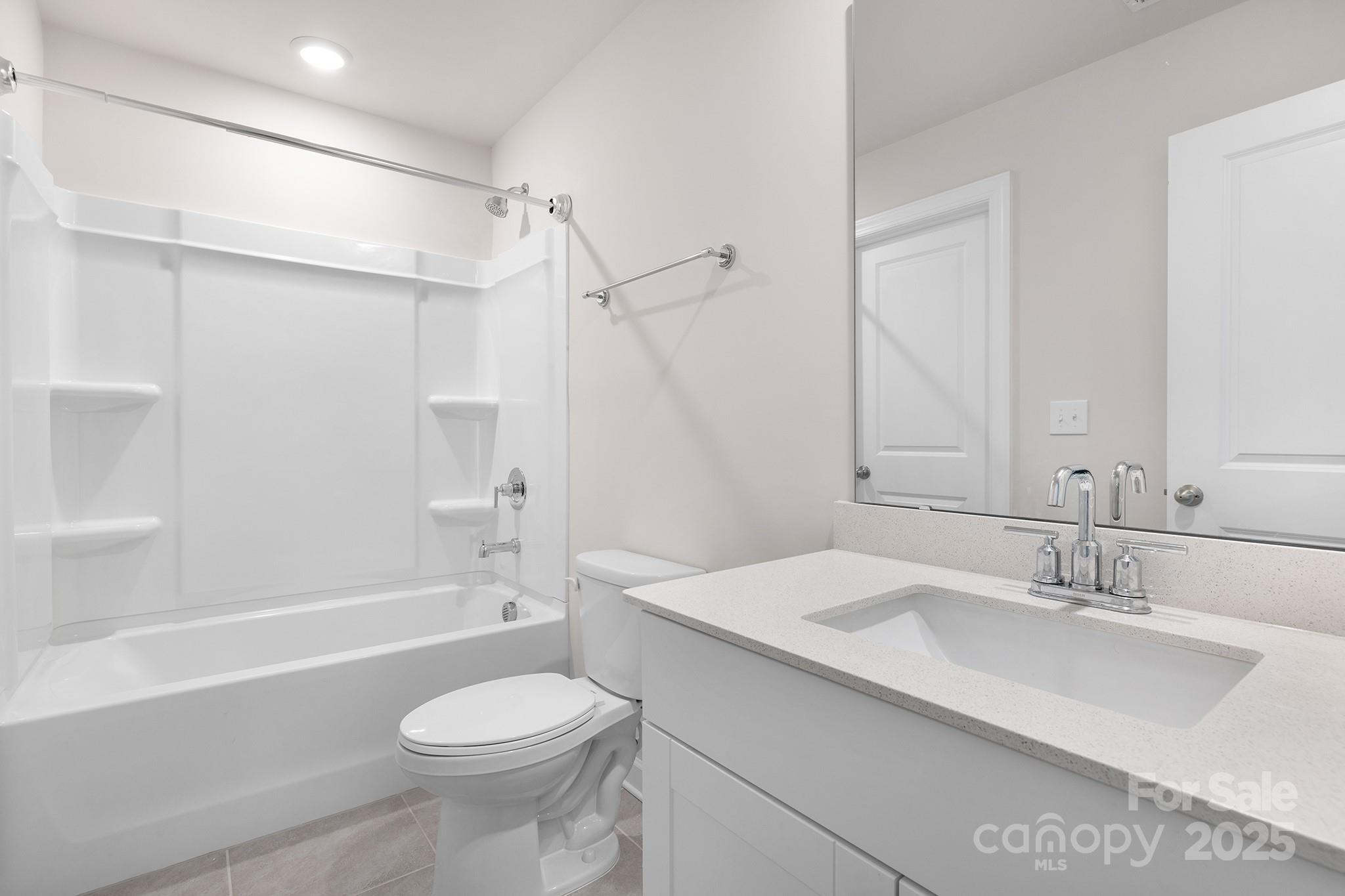 3506 Auburn Curb Road Charlotte, NC 28217 - Photo 18 of 22 a bathroom with a sink toilet vanity and shower