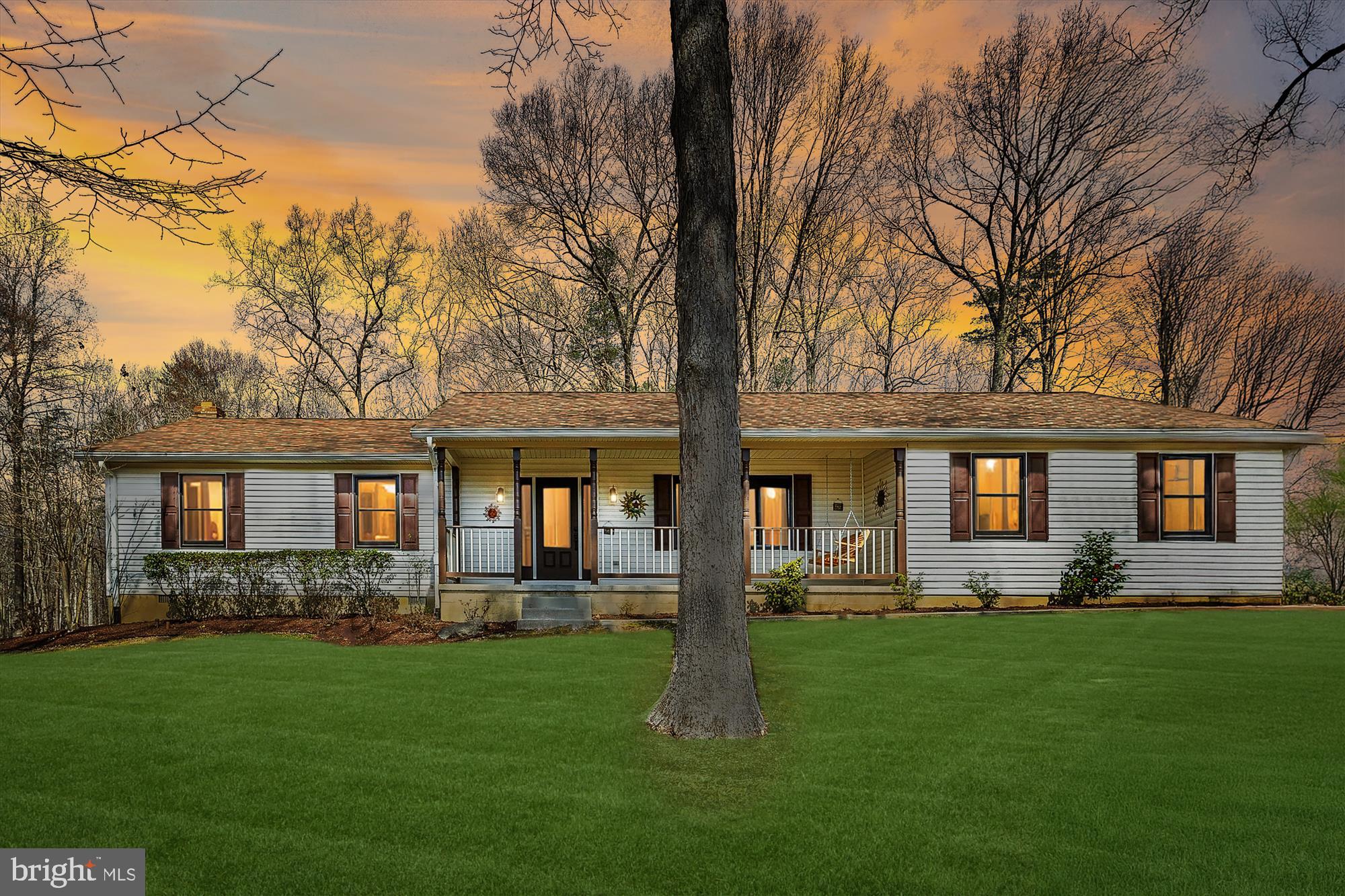 a front view of house with yard and green space