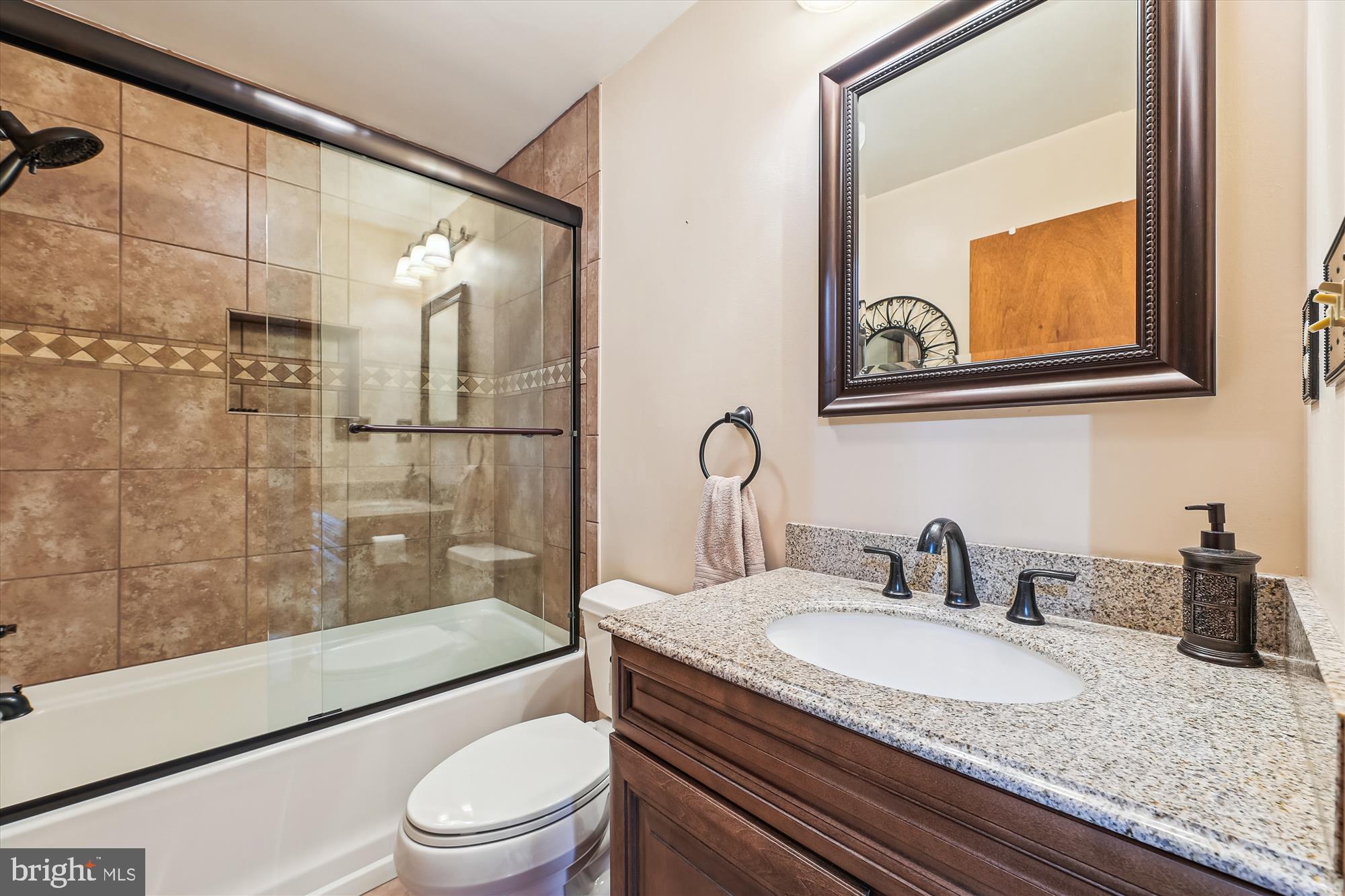 16130 Inheritance Drive Brandywine, MD 20613 - Photo 18 of 39 a bathroom with a granite countertop sink toilet and shower