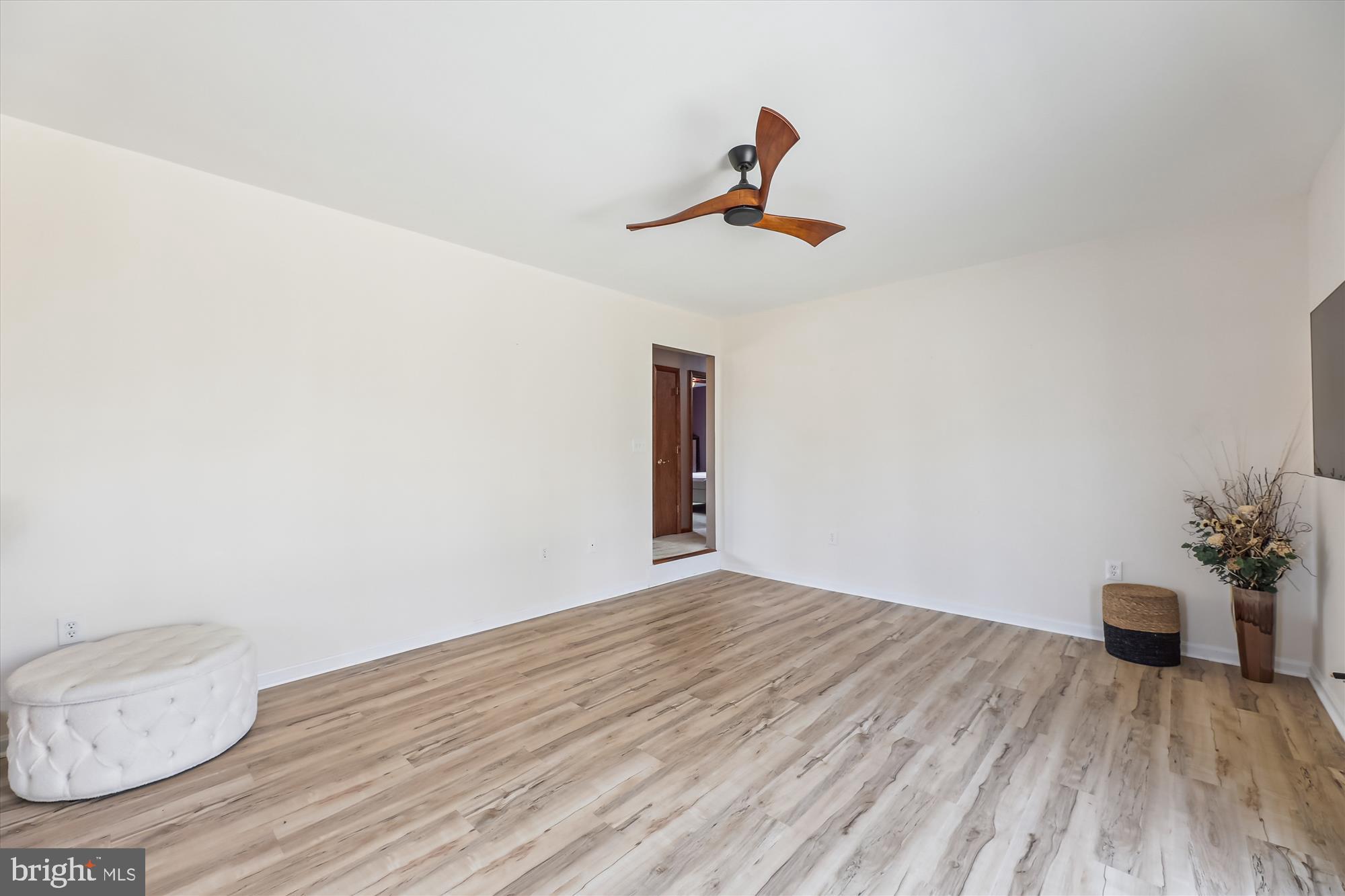 16130 Inheritance Drive Brandywine, MD 20613 - Photo 7 of 39 a view of an empty room with wooden floor and a window