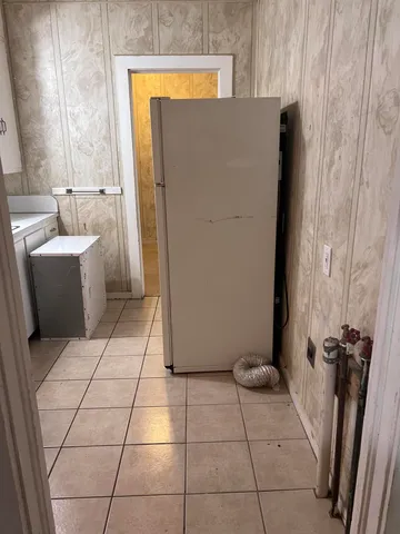 a view of cabinets a sink and a stove in a kitchen