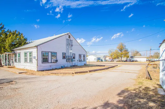 a view of a house with a swimming pool and sitting area