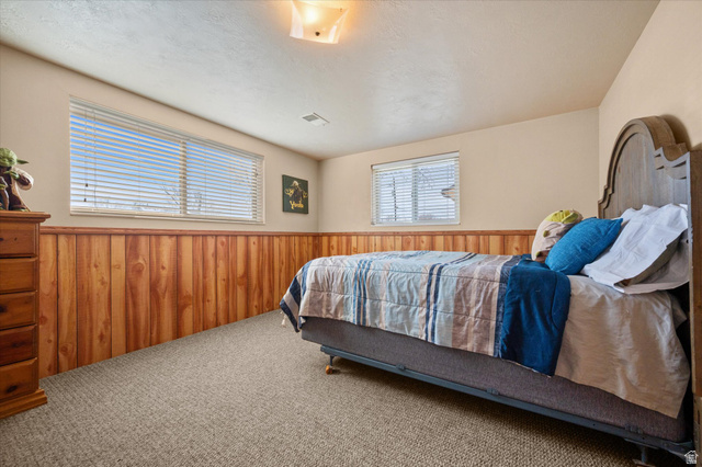 2298 West 800 North Clinton, UT 84015 - Photo 20 of 53 Carpeted bedroom with wooden walls and a wainscoted wall