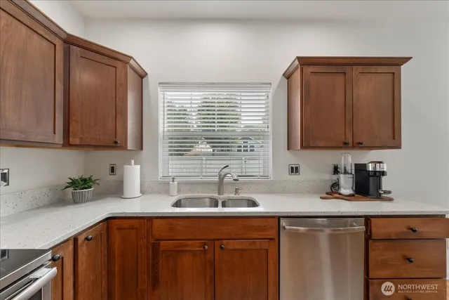 a kitchen with stainless steel appliances granite countertop a sink stove and cabinets