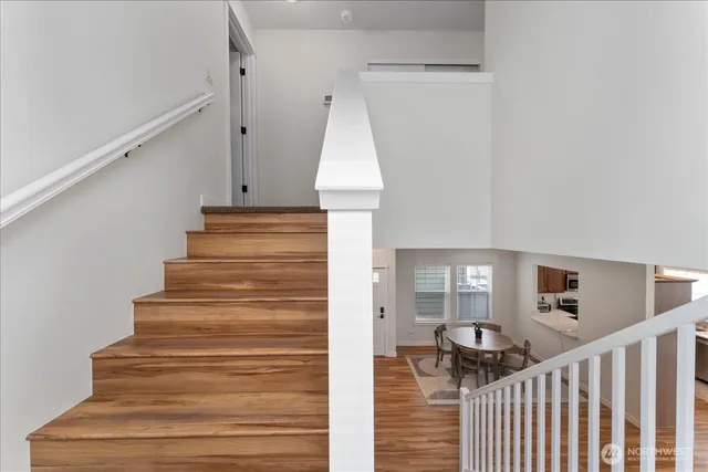 a view of entryway and hall with wooden floor