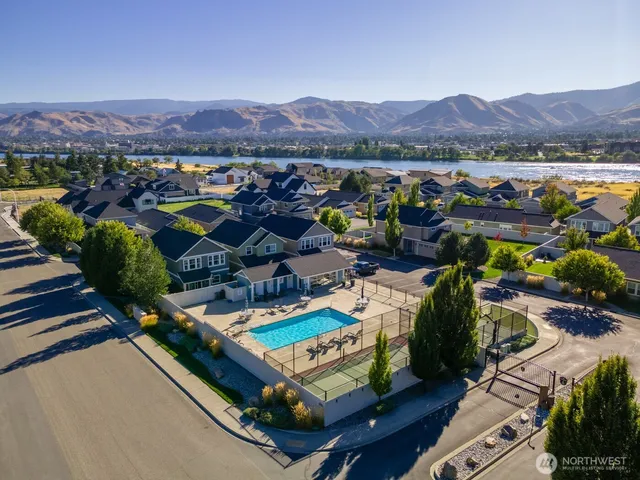 an aerial view of a house with a garden and lake view