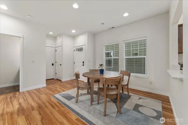 a view of a dining room with furniture and wooden floor