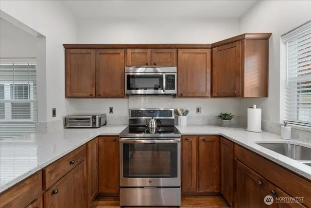 a kitchen with a sink stove and microwave