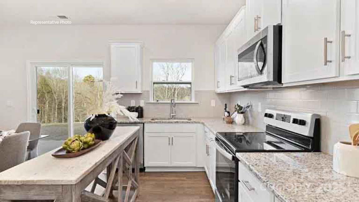 1047 Two Brothers Lane York, SC 29745 - Photo 6 of 18 a kitchen with stainless steel appliances granite countertop a stove a sink a microwave and cabinets