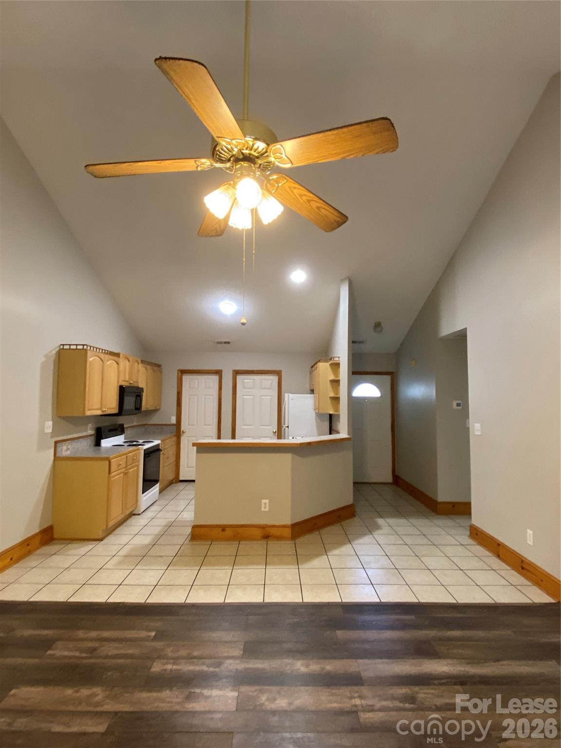 1324 Rustic Lane Northwest Concord, NC 28027 - Photo 11 of 15 a large kitchen with stainless steel appliances kitchen island granite countertop a table chairs and a wooden floor