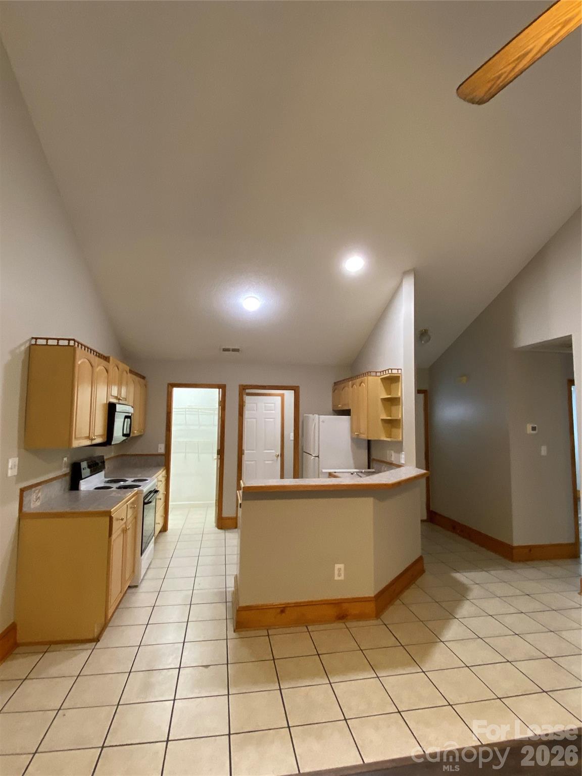 1324 Rustic Lane Northwest Concord, NC 28027 - Photo 12 of 15 a large kitchen with cabinets and a wooden floor