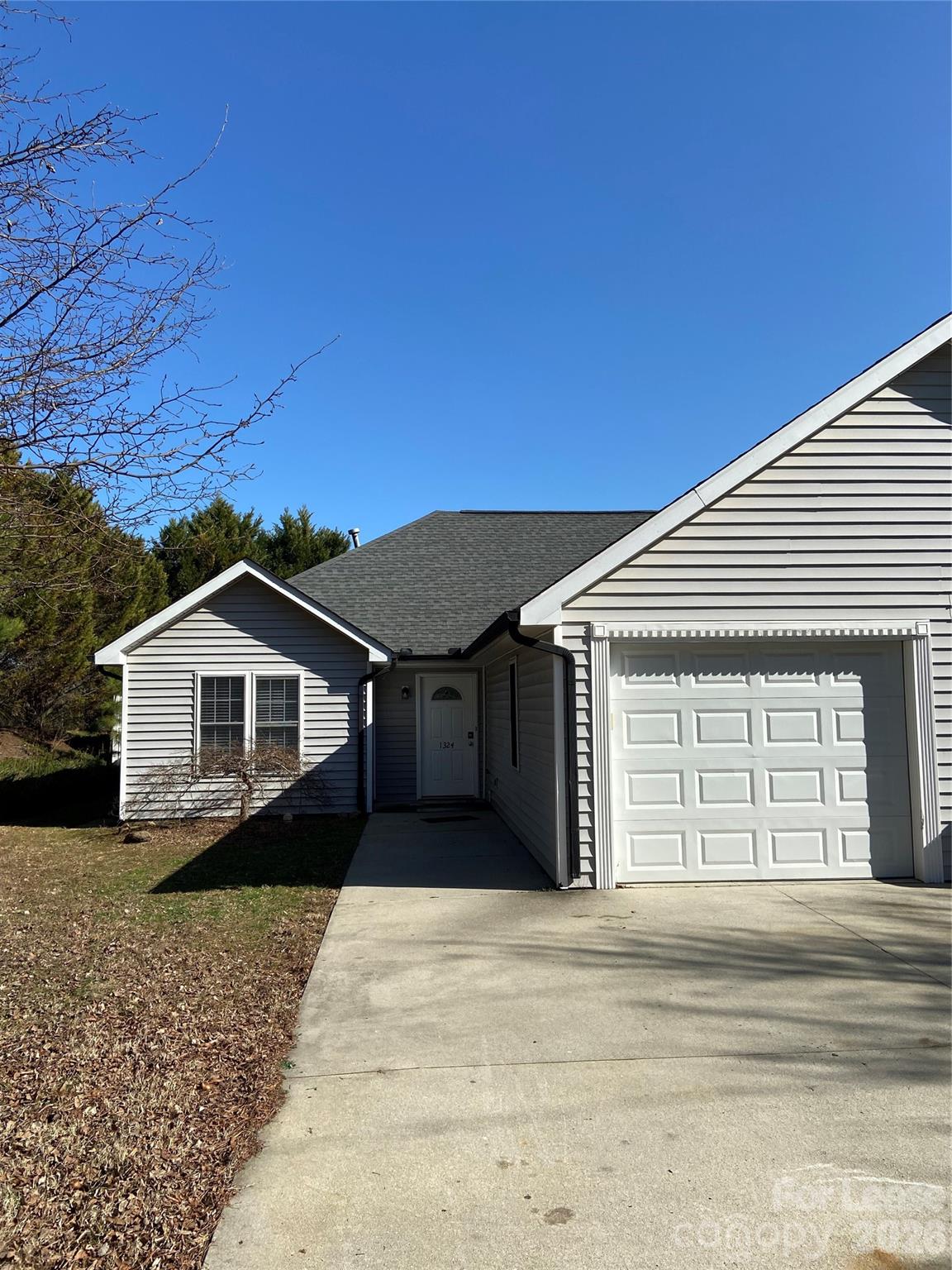 1324 Rustic Lane Northwest Concord, NC 28027 - Photo 2 of 15 a front view of a house with a yard and garage