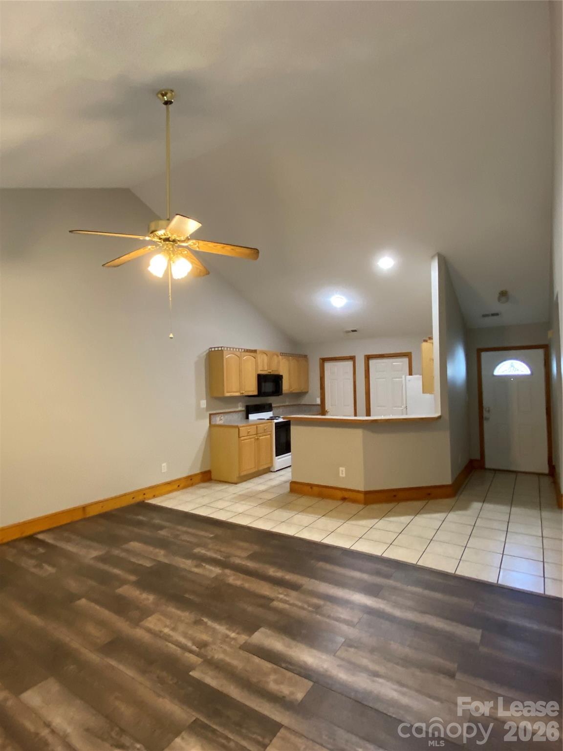 1324 Rustic Lane Northwest Concord, NC 28027 - Photo 3 of 15 a view of a livingroom with a ceiling fan and kitchen view