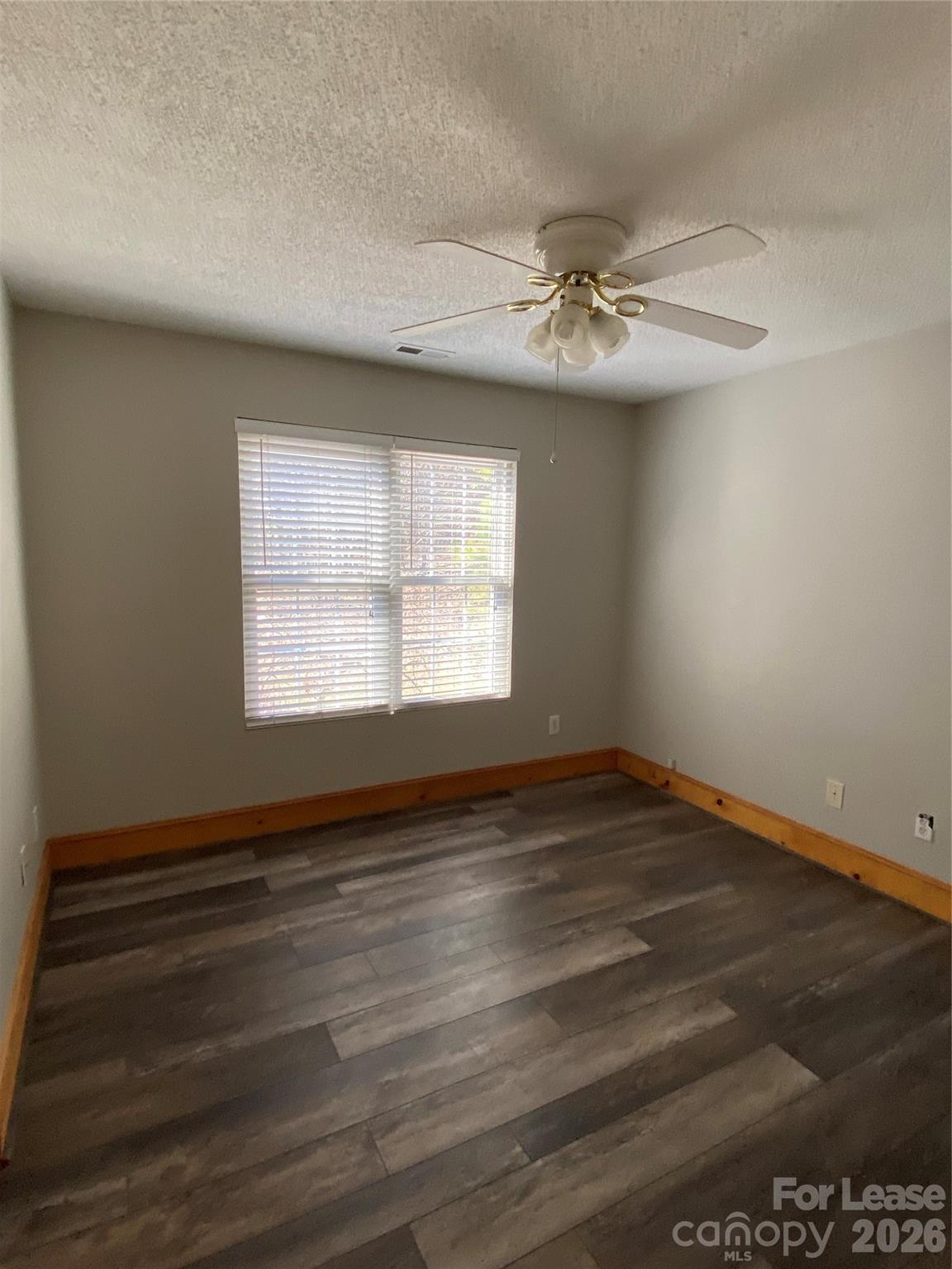 1324 Rustic Lane Northwest Concord, NC 28027 - Photo 9 of 15 wooden floor in an empty room with a window