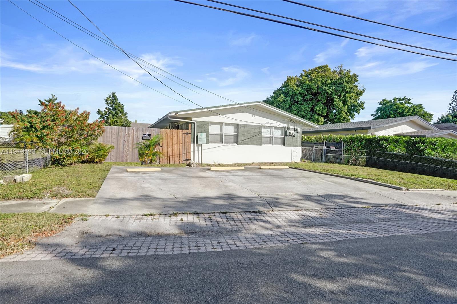 29 Southwest 8th Avenue, Unit 1 Dania Beach, FL 33004 - Photo 1 of 17 a view of a house with a yard