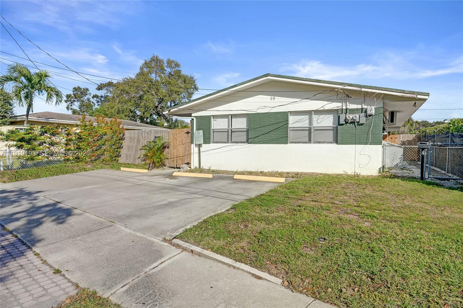 29 Southwest 8th Avenue, Unit 1 Dania Beach, FL 33004 - Photo 2 of 17 a front view of a house with a yard
