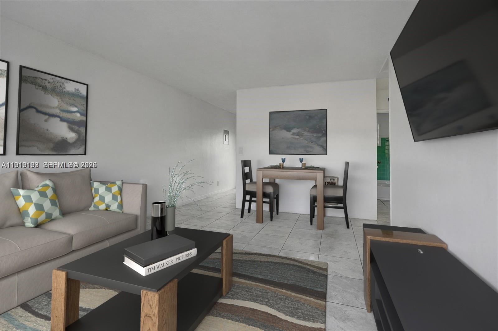 29 Southwest 8th Avenue, Unit 1 Dania Beach, FL 33004 - Photo 3 of 17 a living room with furniture and a flat screen tv