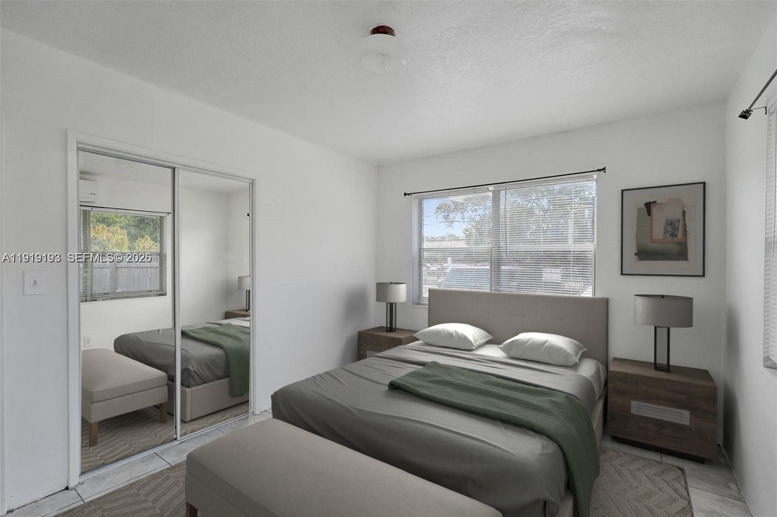29 Southwest 8th Avenue, Unit 1 Dania Beach, FL 33004 - Photo 6 of 17 a living room with a couch and a large window