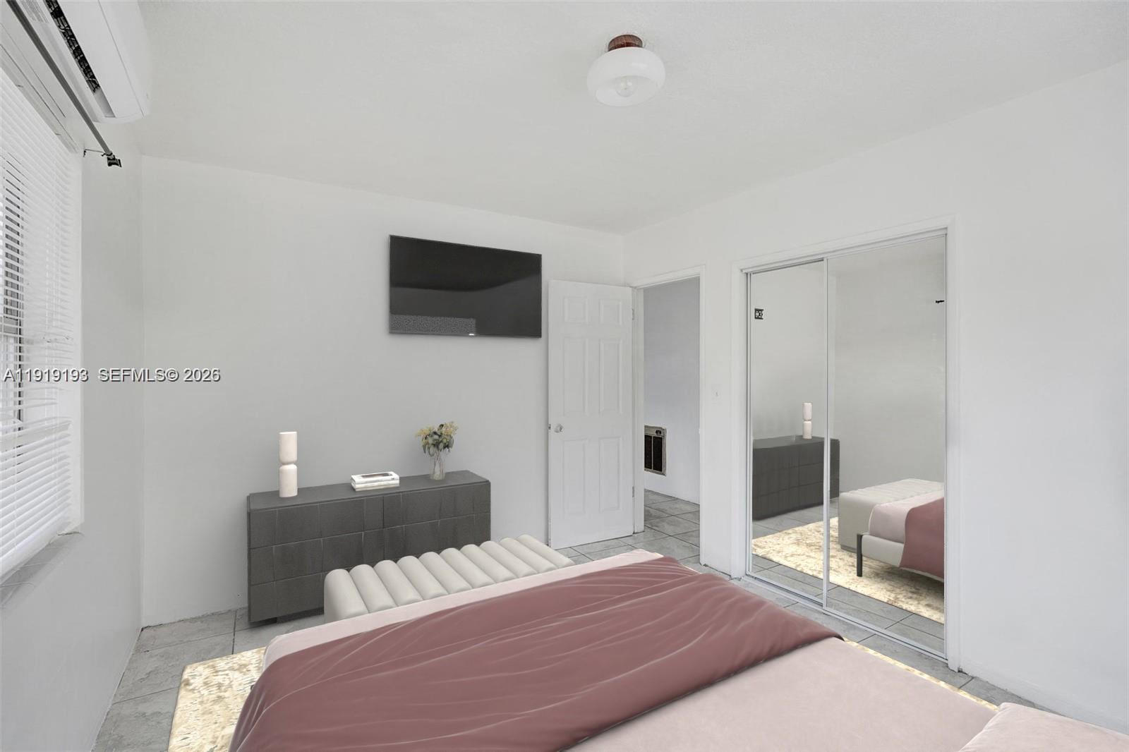 29 Southwest 8th Avenue, Unit 1 Dania Beach, FL 33004 - Photo 7 of 17 a bedroom with a bed and a flat screen tv