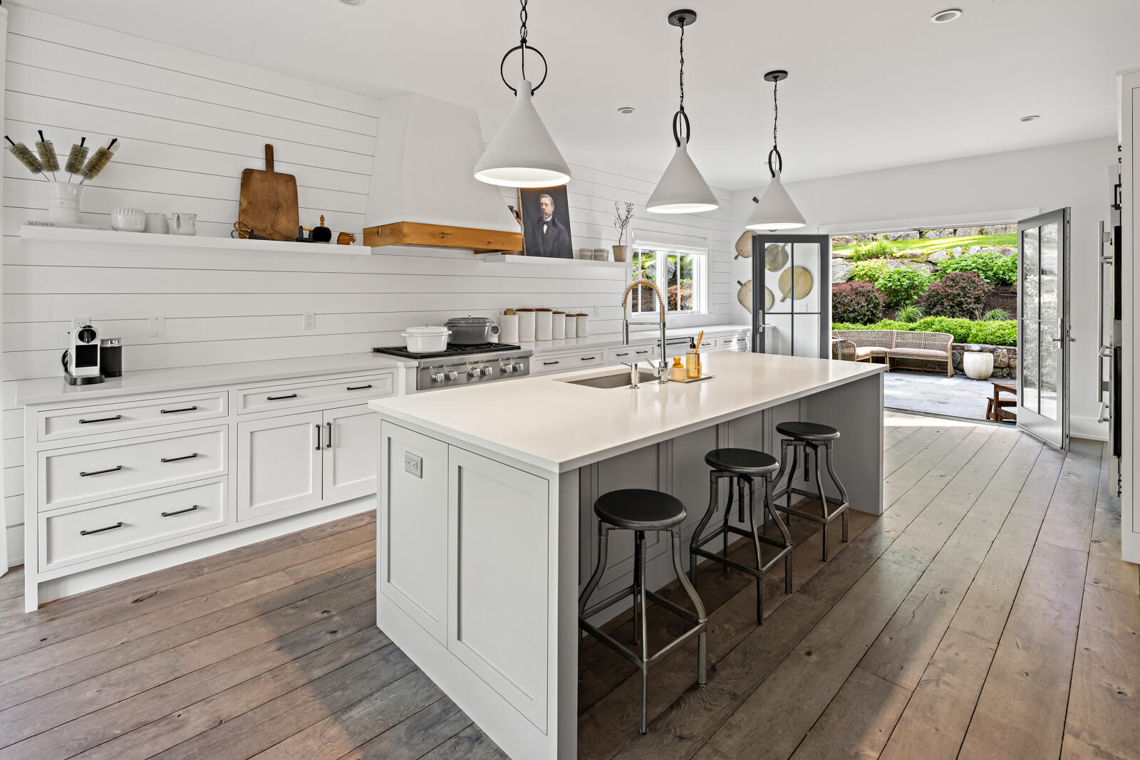 311 Mill Road New Canaan, CT 06840 - Photo 5 of 30 a kitchen with a stove a window and wooden floors