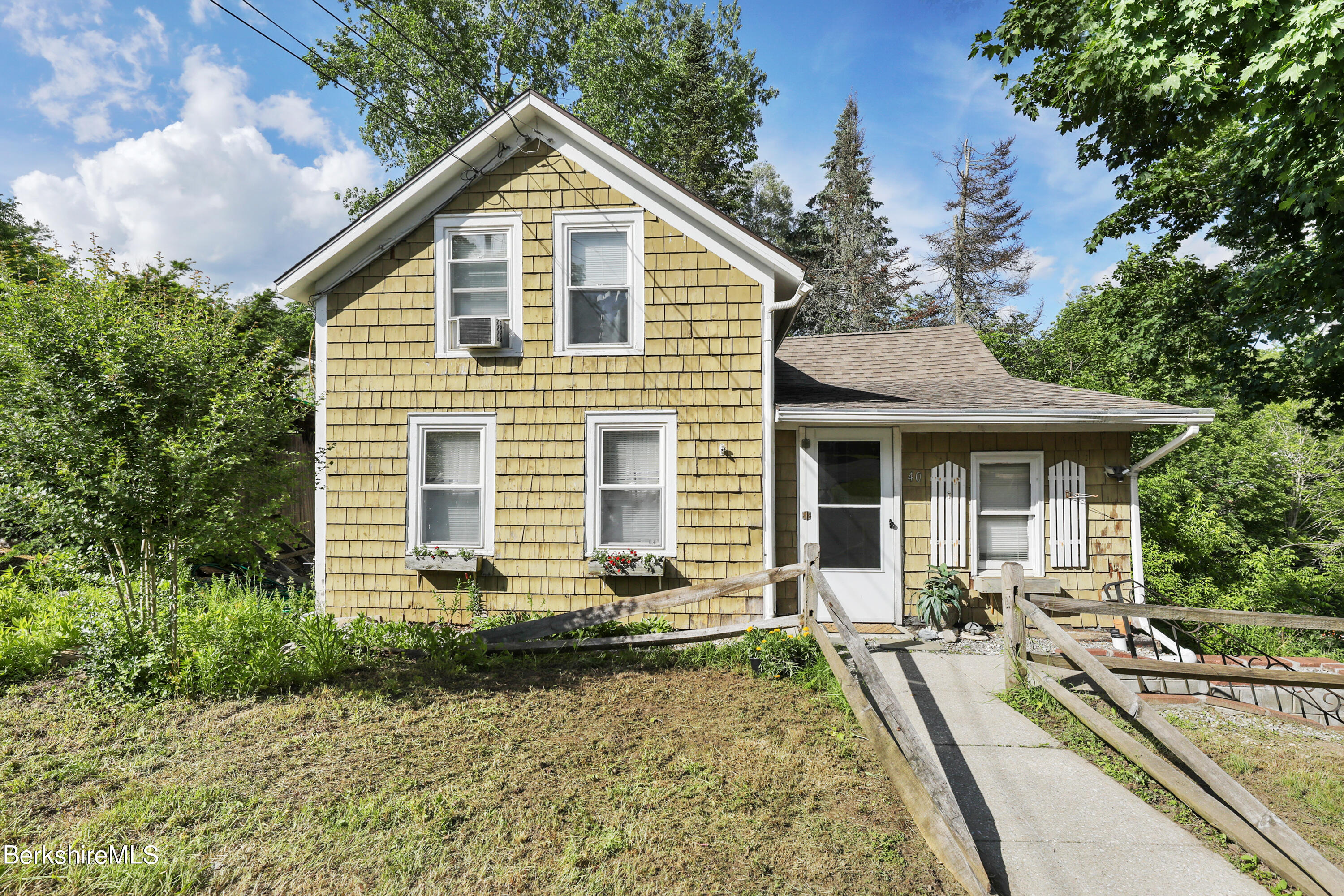 a front view of house with yard and green space