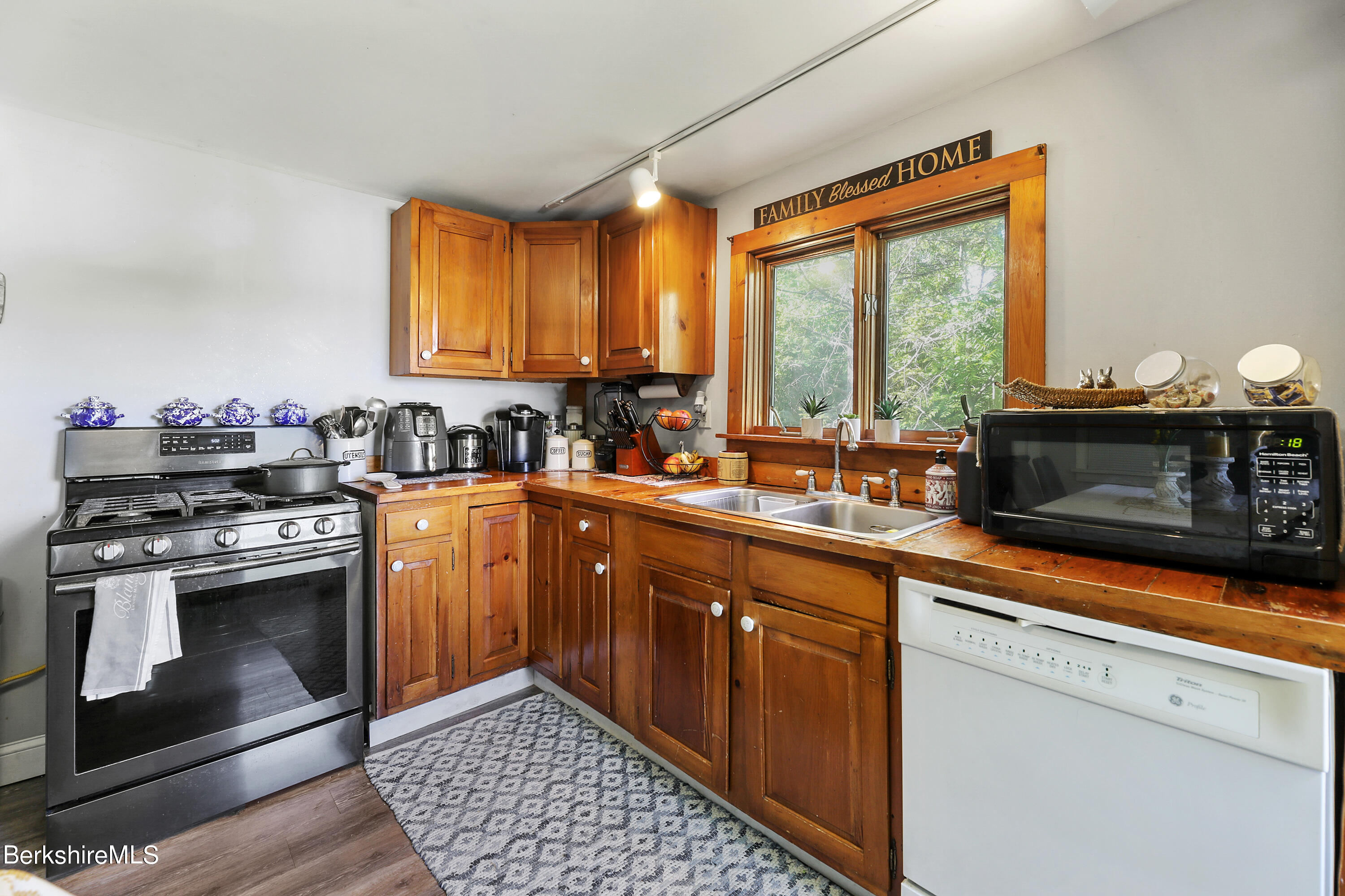 40 Summer Street Lee, MA 01238 - Photo 14 of 19 a kitchen with stainless steel appliances a stove sink and cabinets