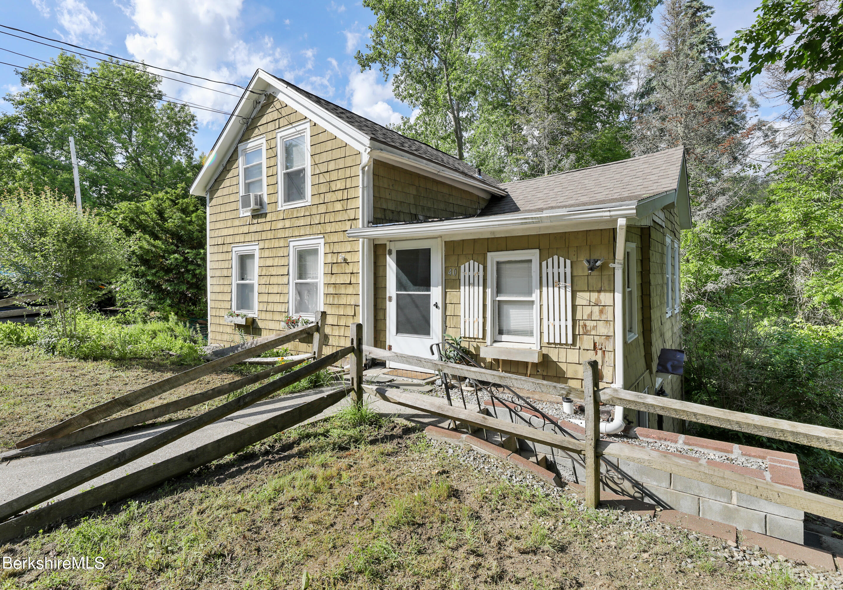 40 Summer Street Lee, MA 01238 - Photo 3 of 19 a house view with a wooden deck and a garden