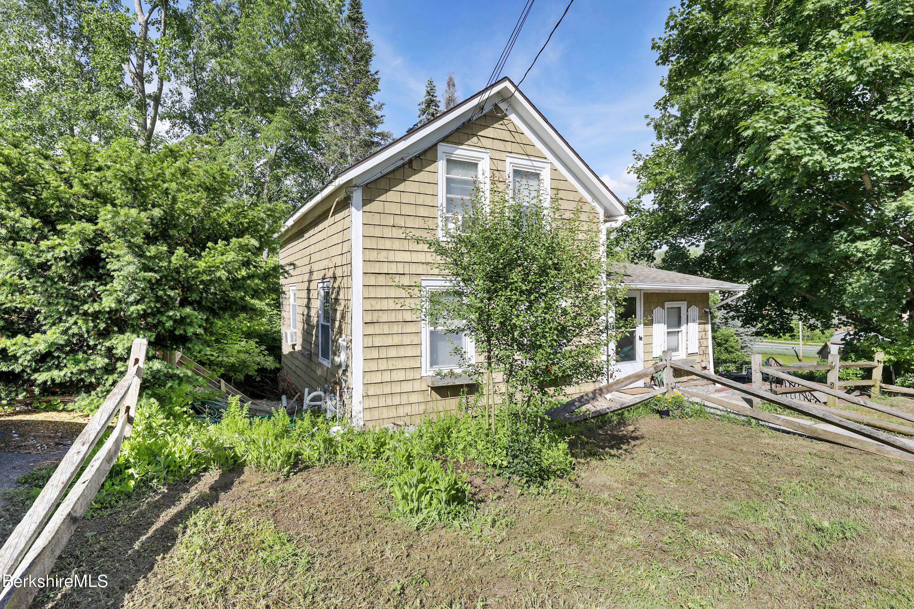 40 Summer Street Lee, MA 01238 - Photo 4 of 19 a view of a house with a yard and plants