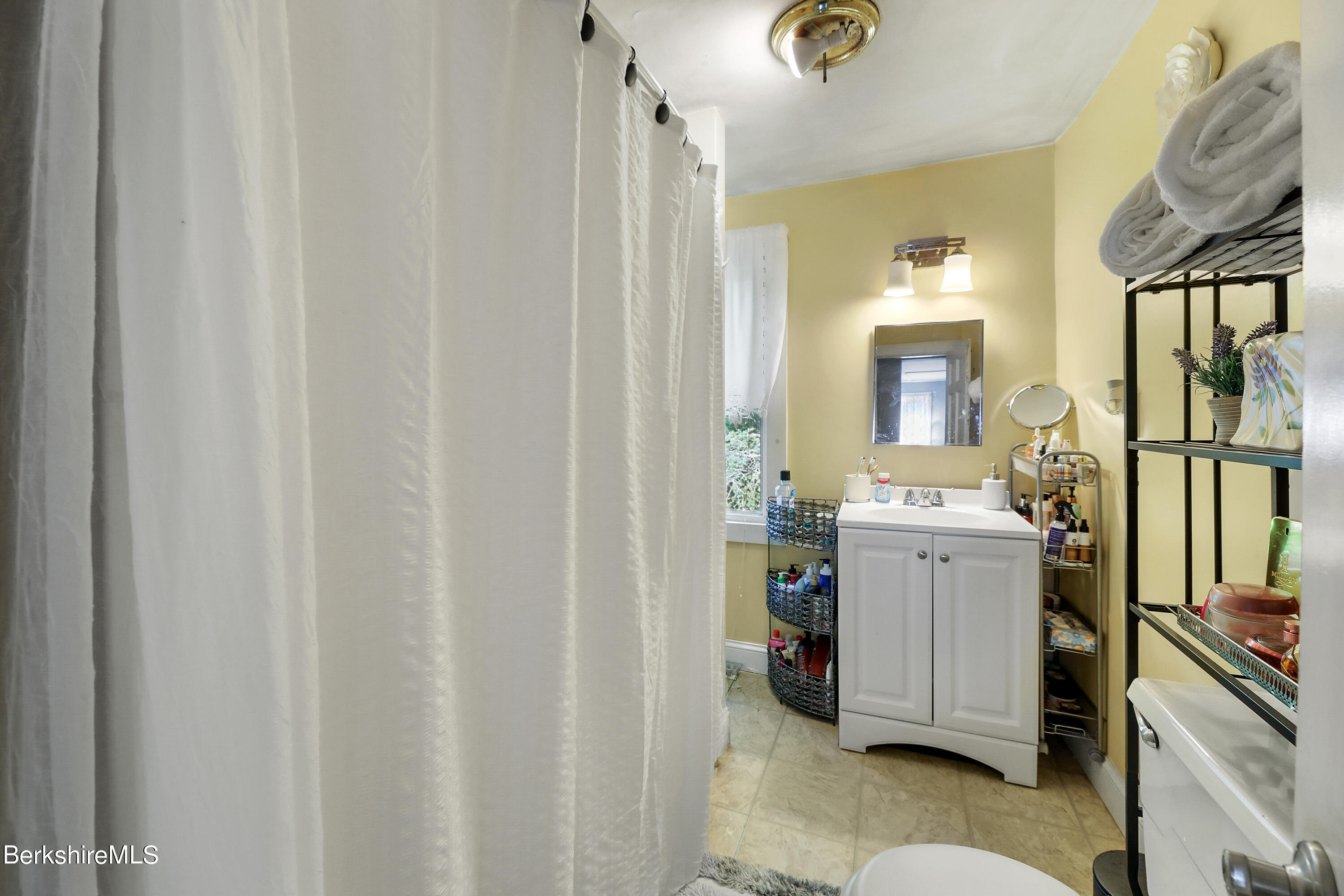 40 Summer Street Lee, MA 01238 - Photo 9 of 19 a room with a sink and a mirror