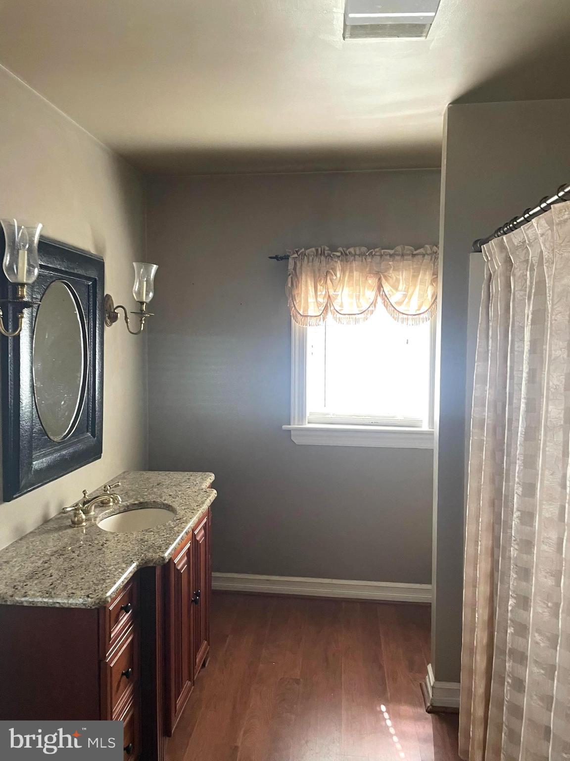 256 Line Road Kennett Square, PA 19348 - Photo 11 of 21 a bathroom with a granite countertop sink a mirror and a toilet