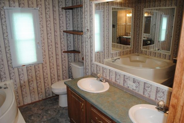 651 Cook Road Portland, TN 37148 - Photo 13 of 18 a bathroom with a sink toilet mirror and shower
