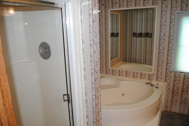 651 Cook Road Portland, TN 37148 - Photo 14 of 18 a bathroom with a tub and shower