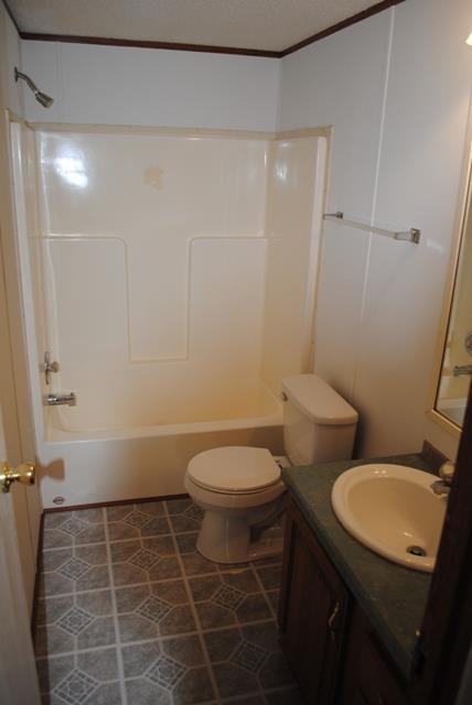 651 Cook Road Portland, TN 37148 - Photo 17 of 18 a bathroom with a toilet a sink and shower