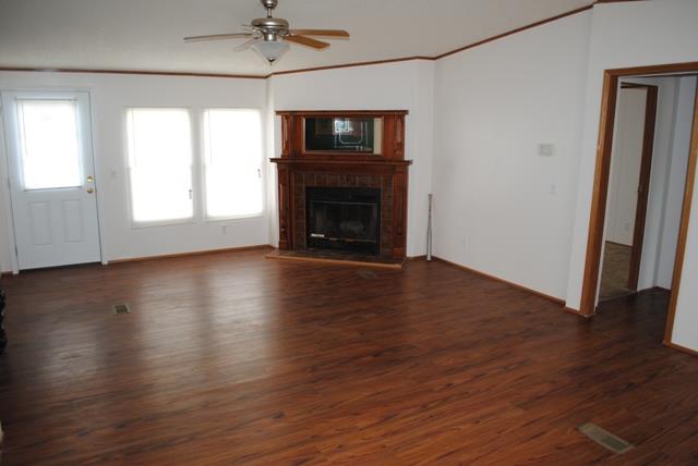 651 Cook Road Portland, TN 37148 - Photo 8 of 18 a view of an empty room with wooden floor fireplace and a window