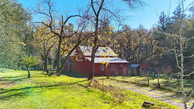 a view of yard with swimming pool and trees
