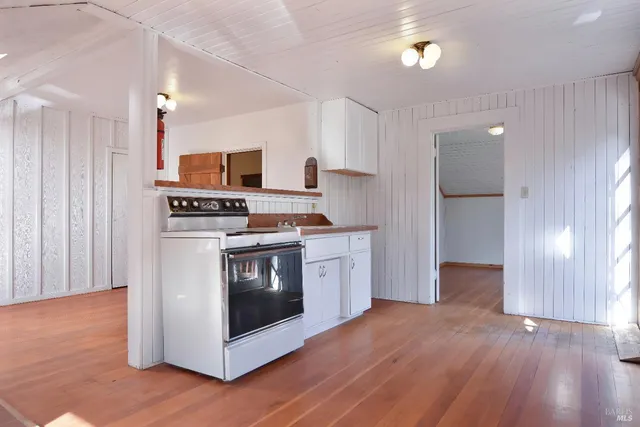 a kitchen with stainless steel appliances a stove top oven and a refrigerator