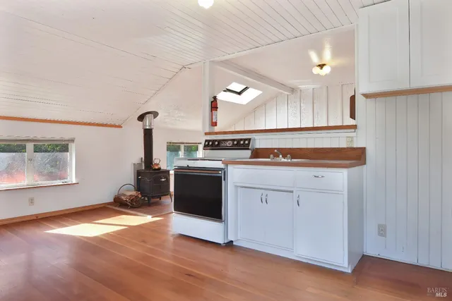 a kitchen with granite countertop a stove and a sink