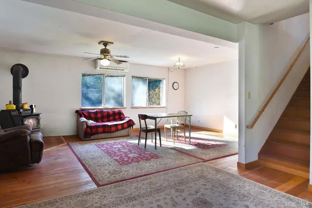 a living room with furniture a rug and a chandelier