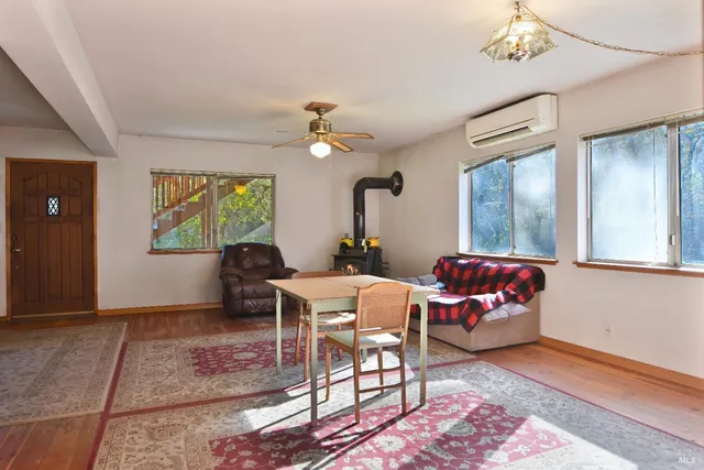 a living room with furniture a chandelier and a window