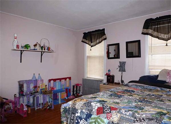 33 Greenleaf Street Springfield, MA 01108 - Photo 11 of 19 a bedroom with a bed a chandelier and flat screen tv