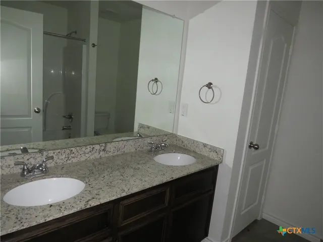 a bathroom with a shower and a toilet