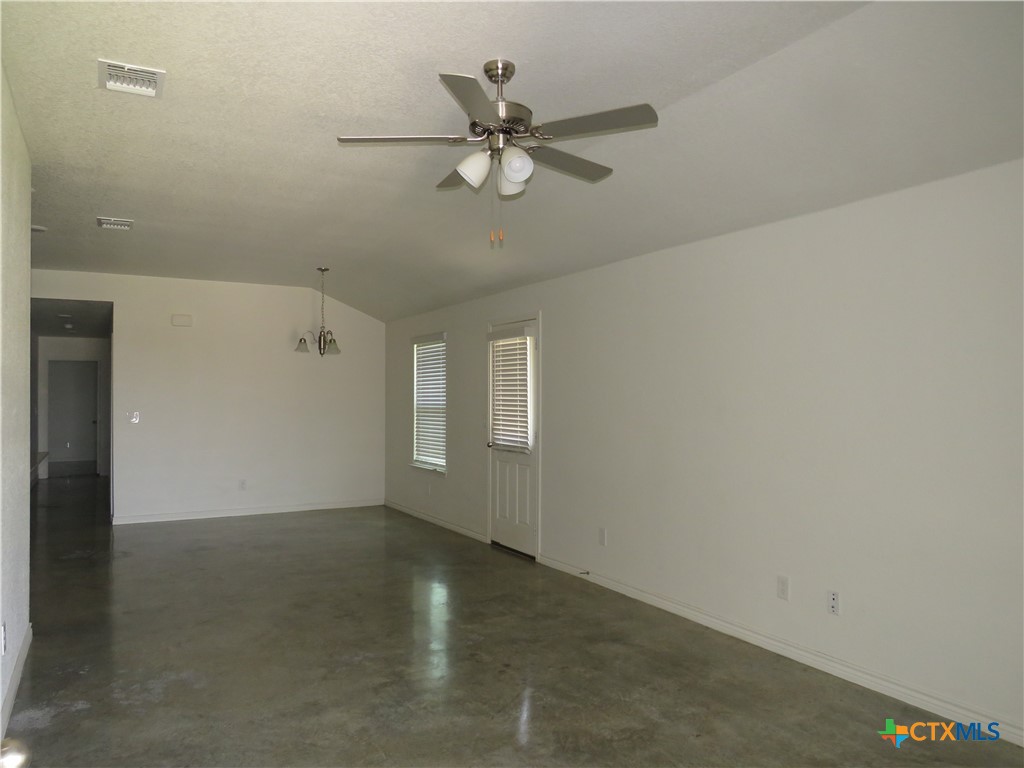 1004 Barbara Jordan Street, Unit B Killeen, TX 76543 - Photo 3 of 13 an empty room with a ceiling fan and windows
