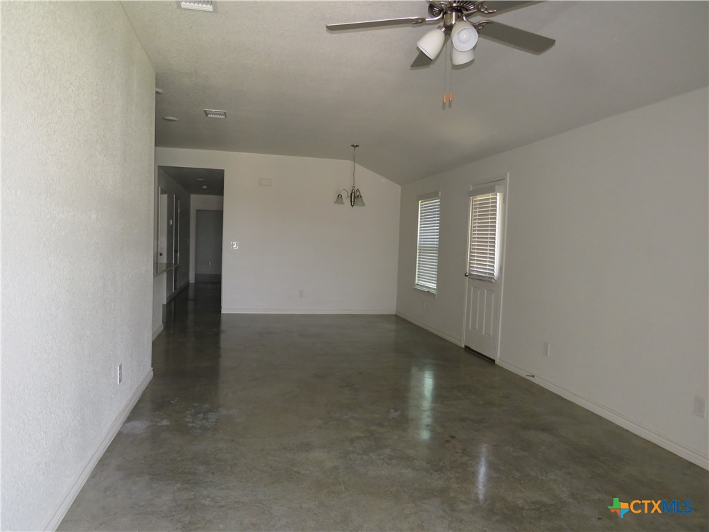 1004 Barbara Jordan Street, Unit B Killeen, TX 76543 - Photo 4 of 13 an empty room with a empty space and a ceiling fan