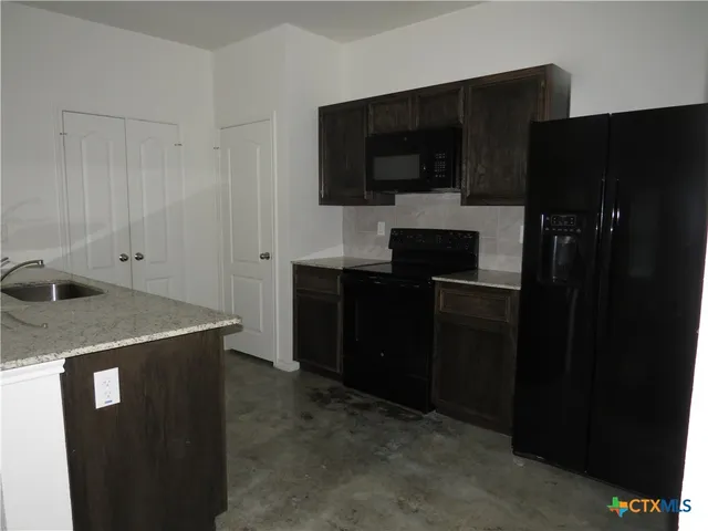 a kitchen with a sink and refrigerator
