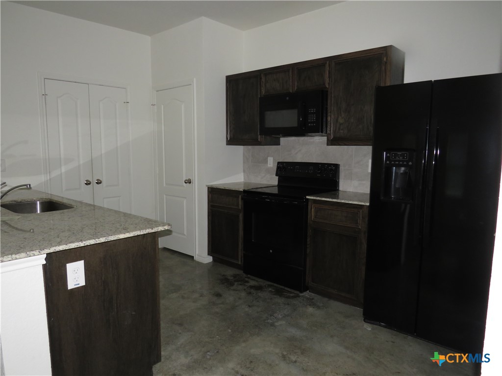 1004 Barbara Jordan Street, Unit B Killeen, TX 76543 - Photo 6 of 13 a kitchen with a sink and refrigerator
