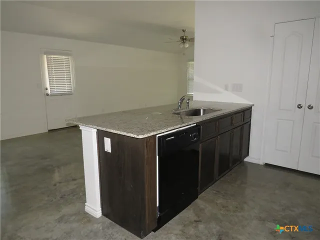 a kitchen with a sink and cabinets