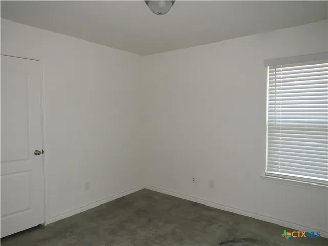 a bathroom with a granite countertop toilet and sink