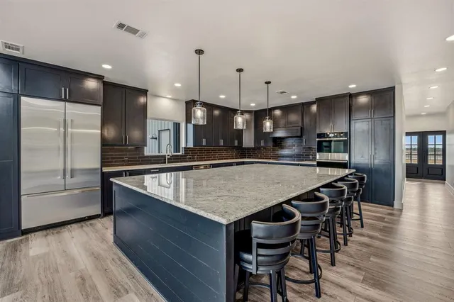 a large kitchen with a table and chairs