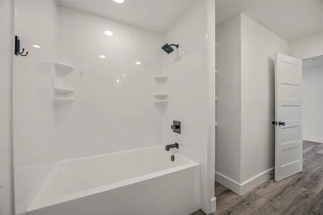 a bathroom with a bathtub and a shower